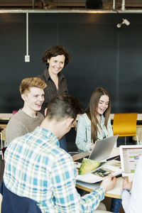 Happy professor training students in university classroom