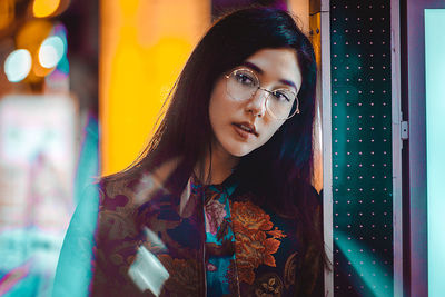 Portrait of young woman standing outdoors