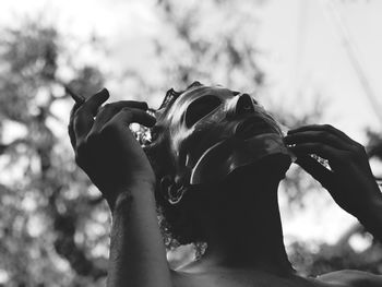 Close-up of woman applying facial mask outdoors