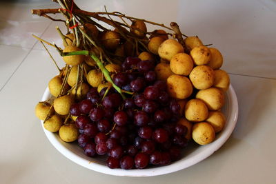 High angle view of grapes in container on table