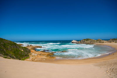 Scenic view of sea against clear blue sky