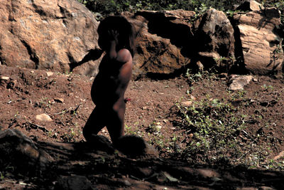 Full length of woman standing on rock