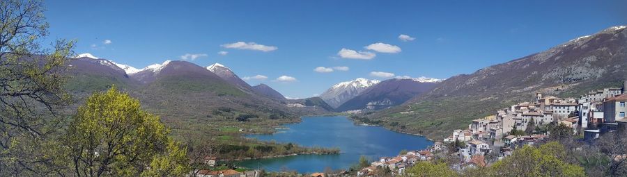 Scenic view of lake and mountains against sky