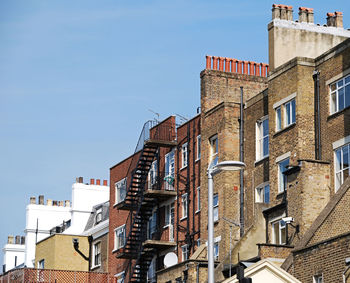 Low angle view of buildings against blue sky