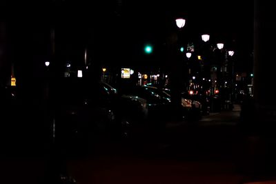 Cars on city street at night