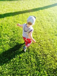 High angle view of baby boy running on grassy land