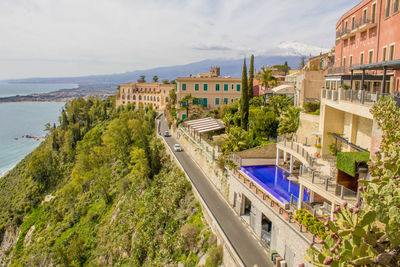 High angle view of buildings by sea against sky