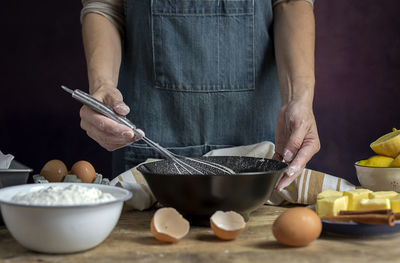 Midsection of man preparing food on table