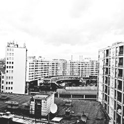 Buildings in city against cloudy sky