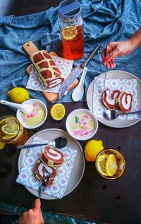 High angle view of hand eating sponge cake served on table