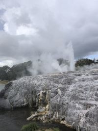 Scenic view of waterfall against sky