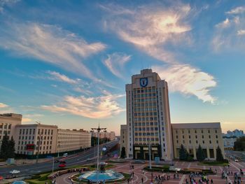 Buildings in city against sky during sunset