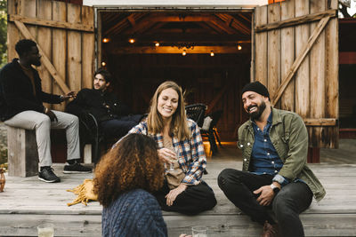 Happy young couple sitting outdoors