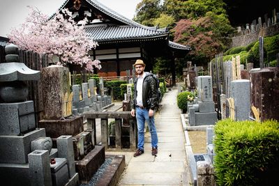 Portrait of smiling young man standing outside temple