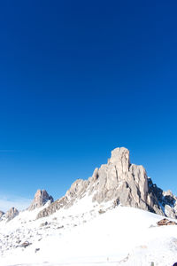 Scenic view of snowcapped mountains against clear blue sky