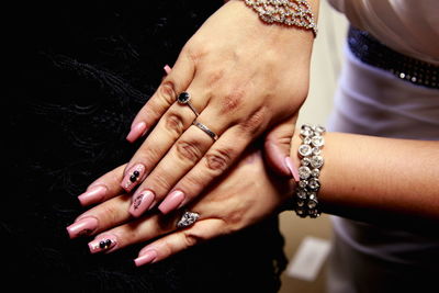 Cropped image of woman hands on black velvet