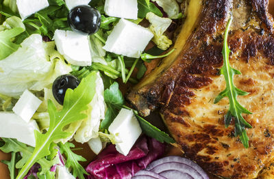 Close-up of roasted pork and salad