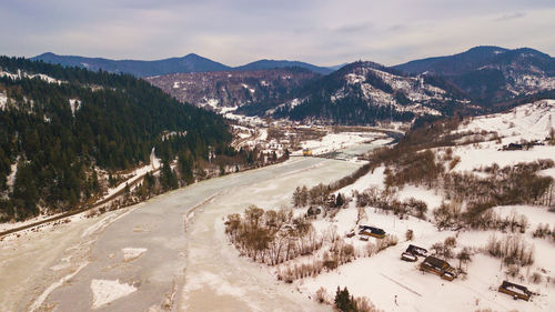 High angle view of snowcapped mountains against sky