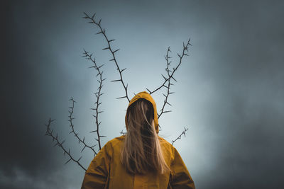 Girl with long hair in yellow hood,  tree with thorns, depression, mysticism, dark thoughts