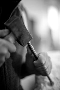 Close-up of cropped hand holding cigarette