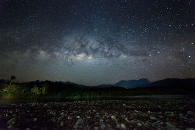 Scenic view of mountains against sky at night