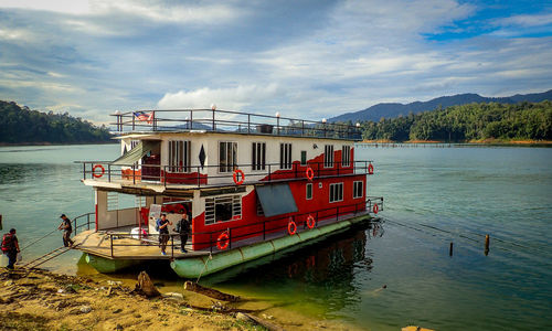 Boat moored on river against sky