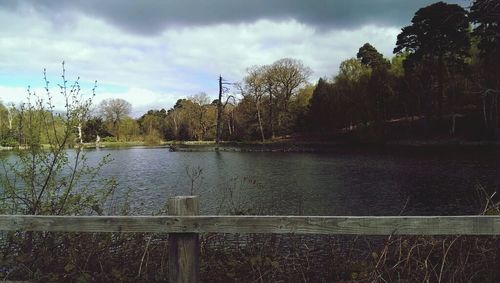 Scenic view of lake against cloudy sky