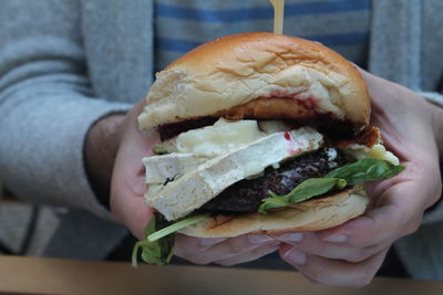 Close-up of man holding burger