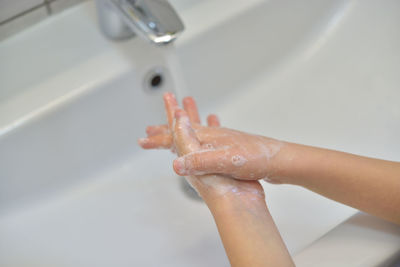 Midsection of woman in bathroom at home