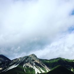 Scenic view of rocky mountains against cloudy sky