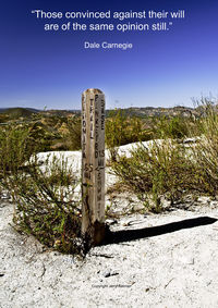 Information sign on landscape against clear sky