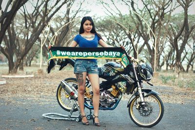 Portrait of woman riding bicycle on road