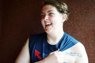 Portrait of beautiful young woman holding camera