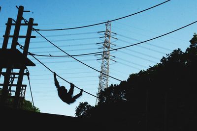 Low angle view of power lines against sky