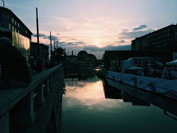 Boats moored at harbor during sunset