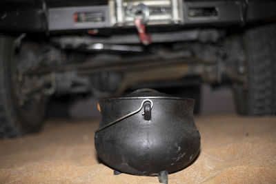 Close-up of south african potjie in front of an suv