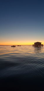 Scenic view of sea against clear sky during sunset