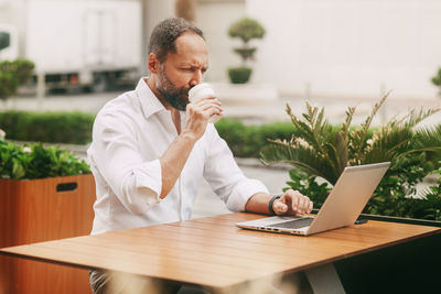 Businessman using laptop at table