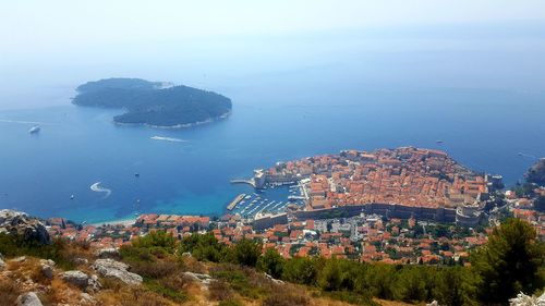 High angle view of sea and buildings in city