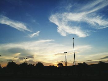 Low angle view of silhouette trees against sky