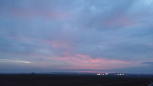 Scenic view of landscape against cloudy sky