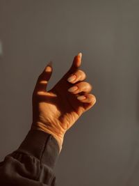 Close-up of human hand against black background