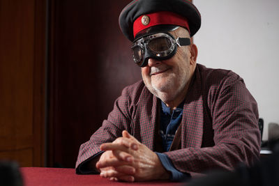 Smiling senior man wearing aviator glasses and cap