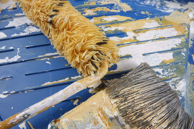 Close-up of paintbrush and roller