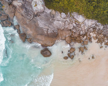 High angle view of rocks by sea