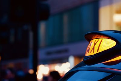 Close-up of illuminated car on street at night