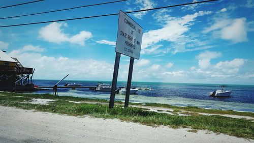 View of calm blue sea against cloudy sky