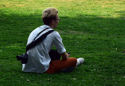 Rear view of boy playing on field