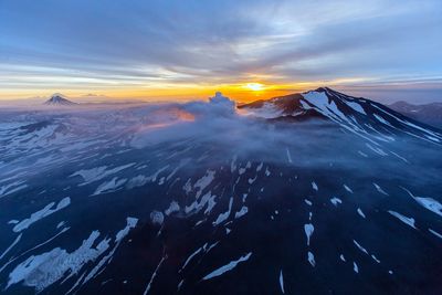 Aerial view of landscape against dramatic sky during sunset