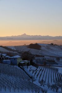 High angle view of snow field against sky during sunset